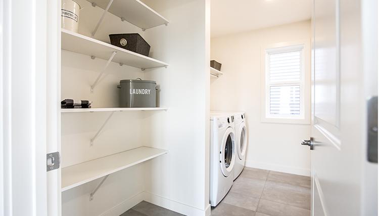 Laundry room in the Isaiah showhome by San
Rufo Homes in Rocha in the Orchards, Edmonton.